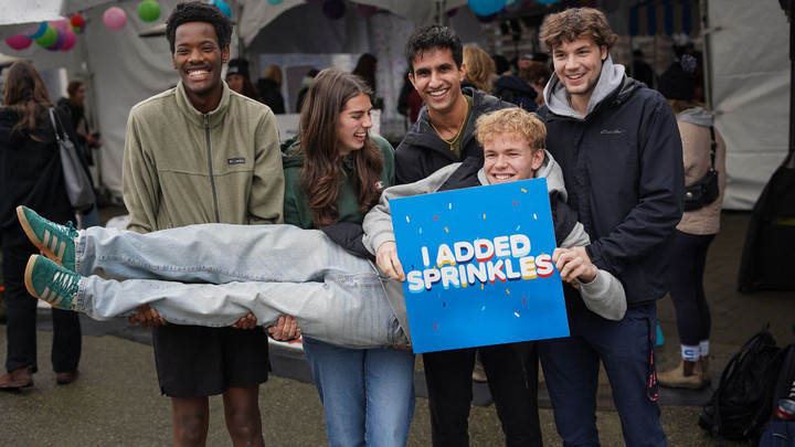 Students smiling outside the Giving Tuesday tent