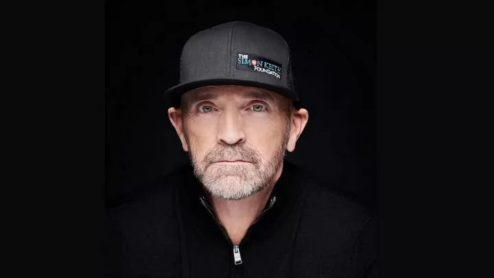 A man wearing a black baseball hat that reads Simon Keith Foundation.