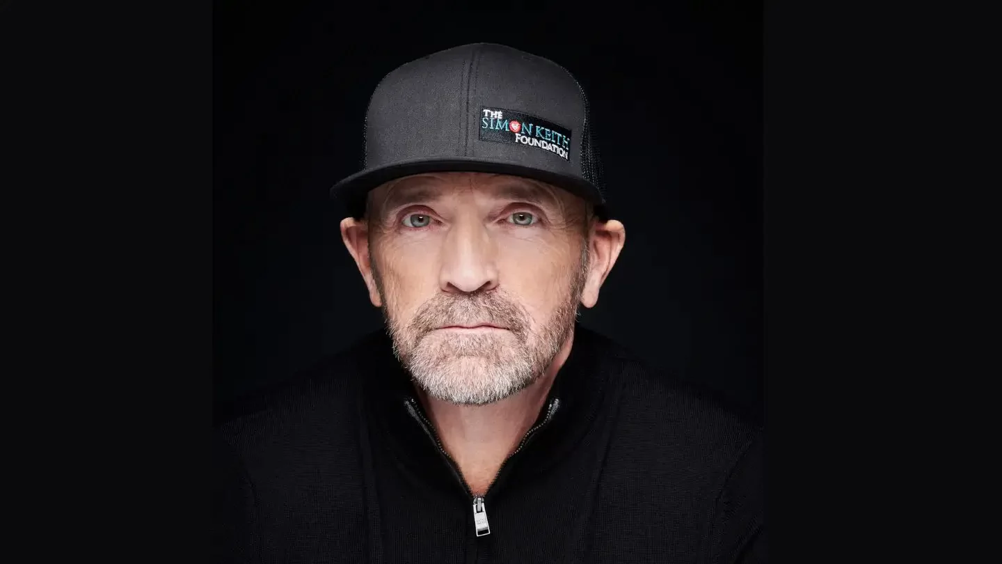 A man wearing a black baseball hat that reads Simon Keith Foundation.