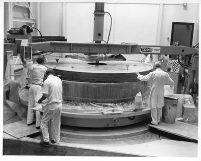 4 men inspect the polished Canada France Hawaii Telescope mirror