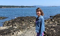 Patricia standing on a rock at Cattle Point