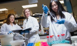 Swayne in her lab with fellow researchers