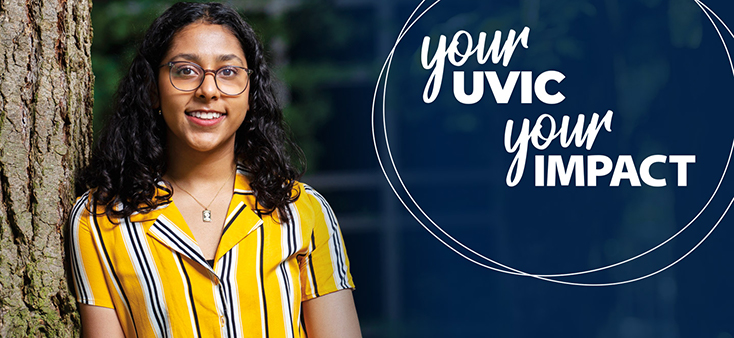 A girl with long dark curly hair and glasses, wearing a bright yellow striped shirt, leans against a tree. The text overlay reads Your UVic, Your Impact.