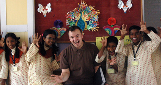 Gus with children in the theatre project