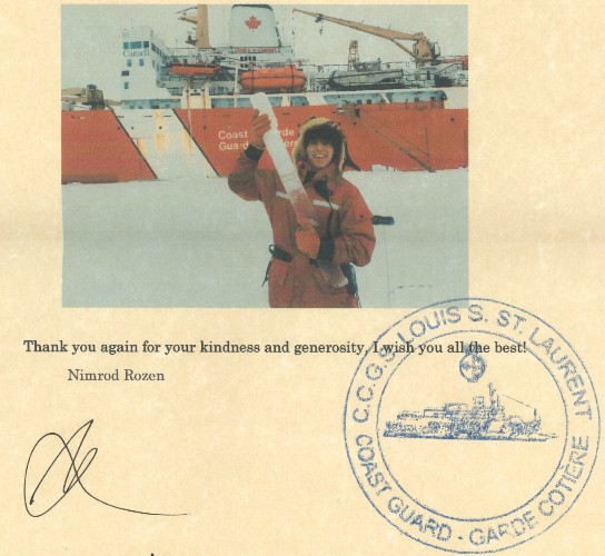 This is a small extract of a letter on yellowed paper that includes a photo of the student in front of the research vessel holding an ice sample. The letter bears the stamp of the coast guard vessel.
