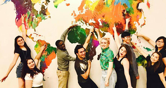 Students in front of world map