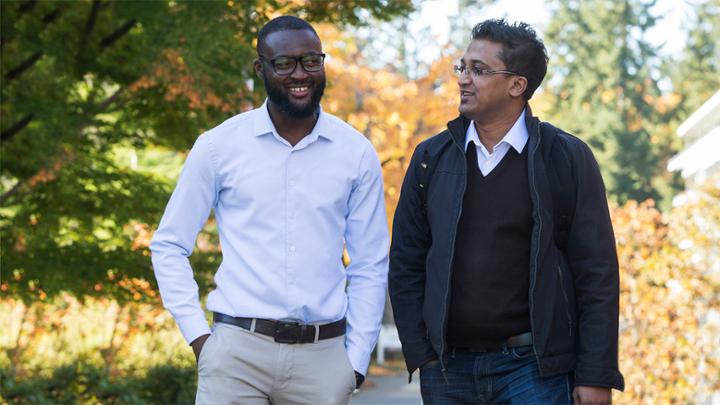 Two visiting international graduate students walking on campus