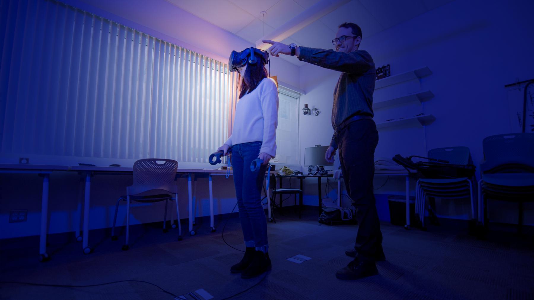 professor with student wearing AR goggles