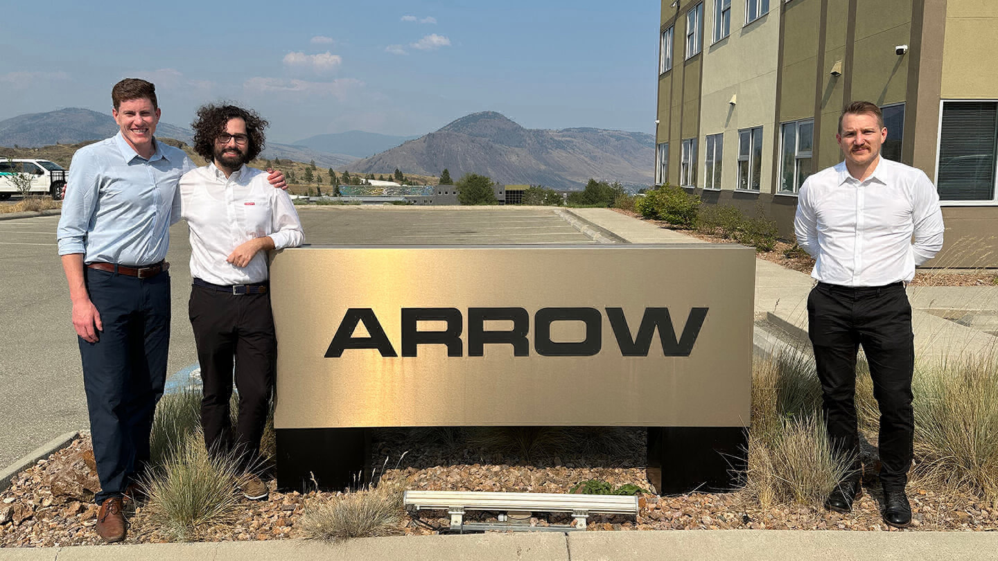 Jacob Adams, Ian Schoeddert and Taylor Entz by the outdoor sign at Arrow Transportation