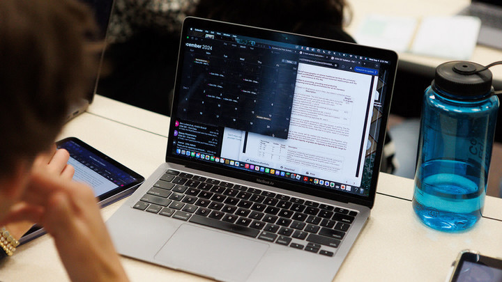 A student working on their laptop in class