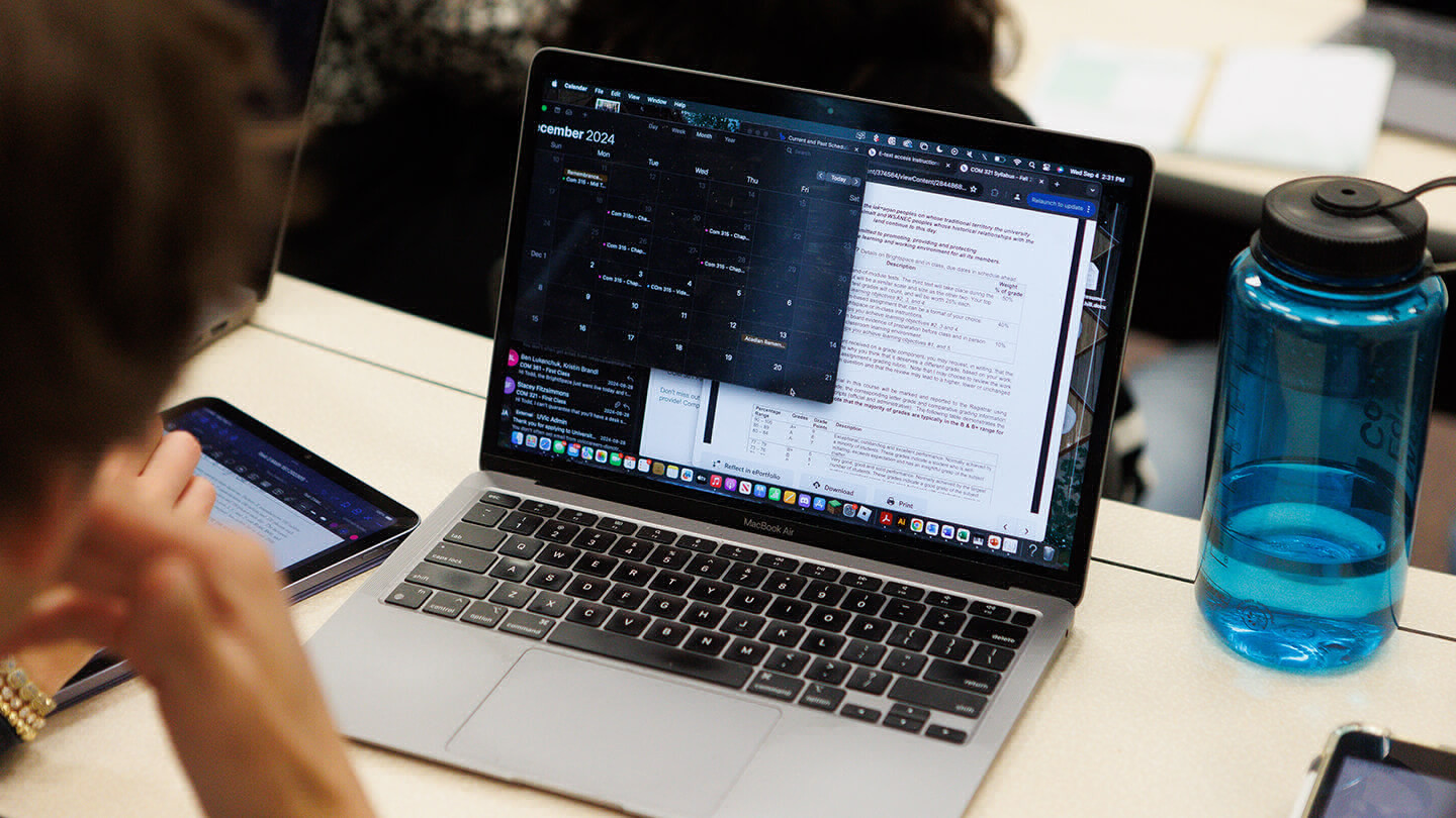 A student working on their laptop in class
