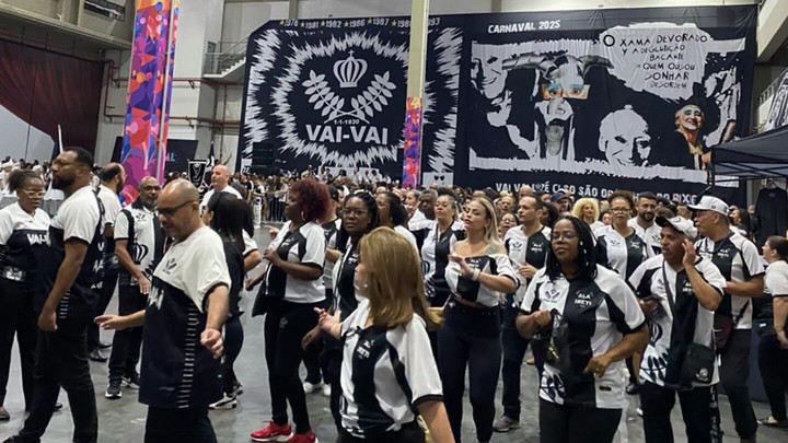 Group at Carnival in front of a giant banner