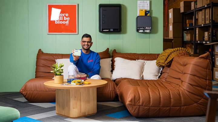 Jayesh Vekariya from joni on a couch holding one of the products