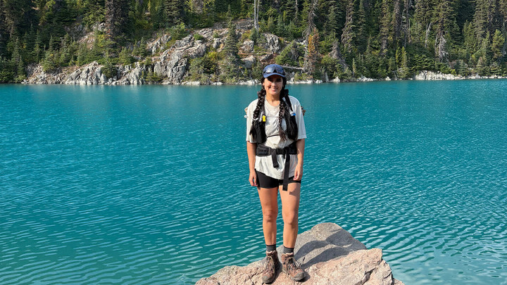 Linh Sa Arnold on a hike by an emerald-colour lake