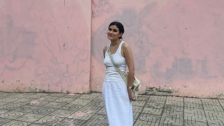 Linh Sa Arnold in front of a pink wall