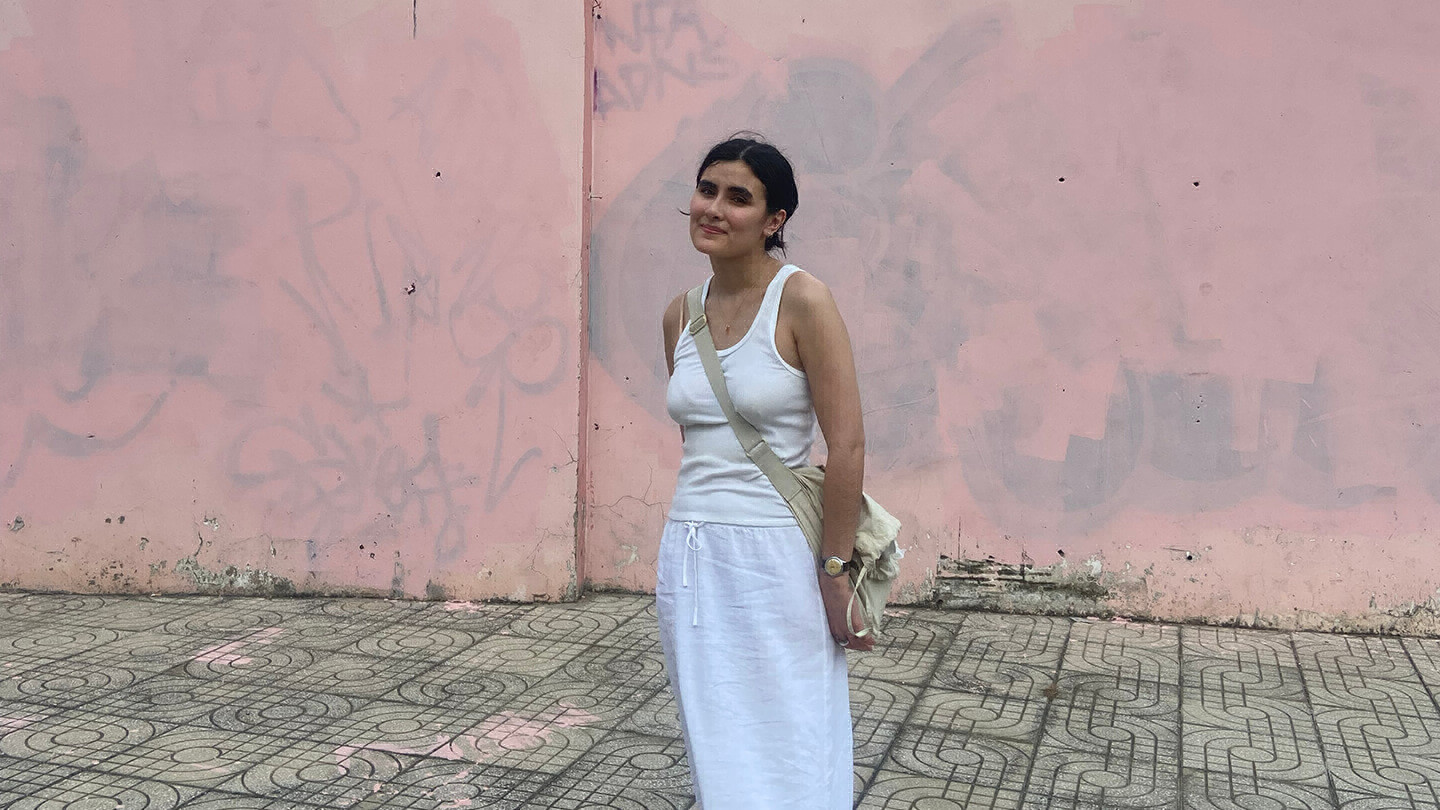 Linh Sa Arnold in front of a pink wall
