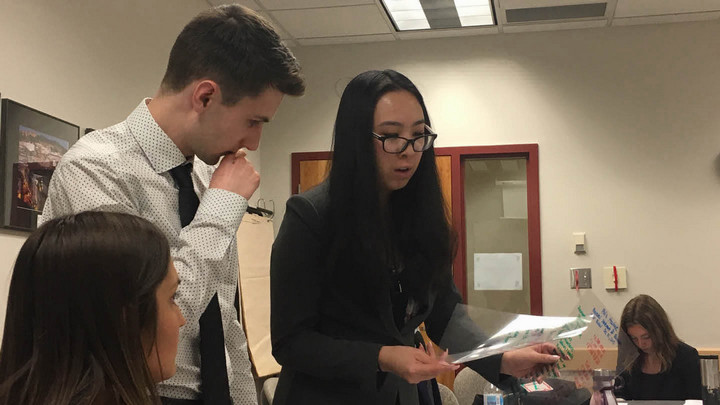 The group members of Team 58 do the final review of their presentation