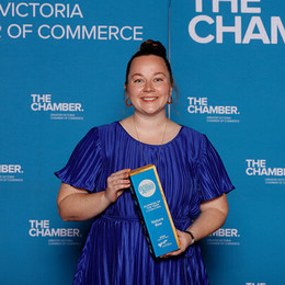 Katie Gamble with an award from the Victoria Chamber of Commerce