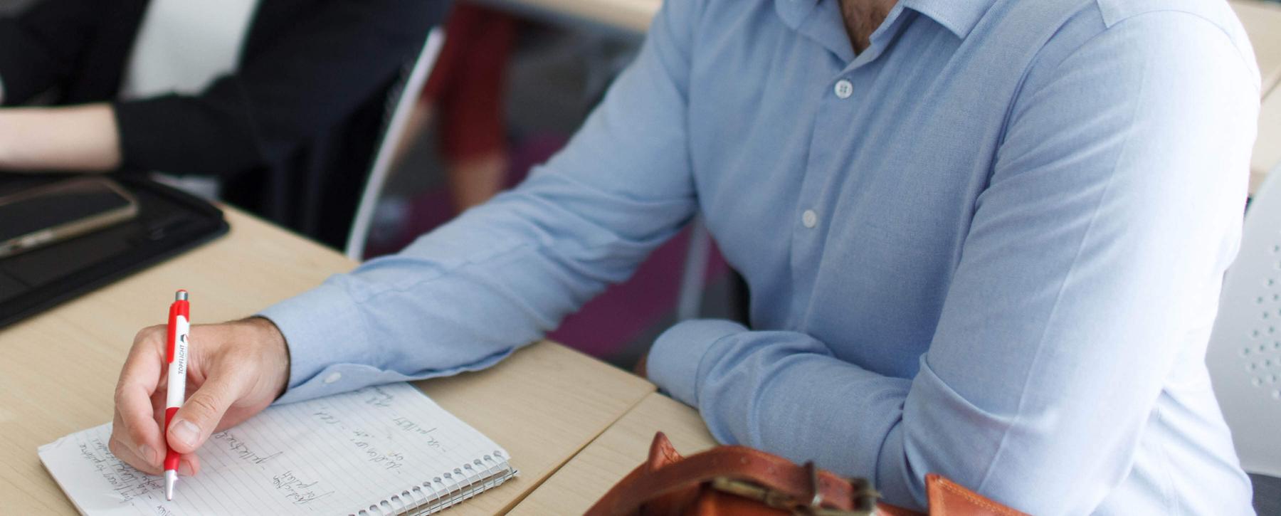 Man taking notes at desk
