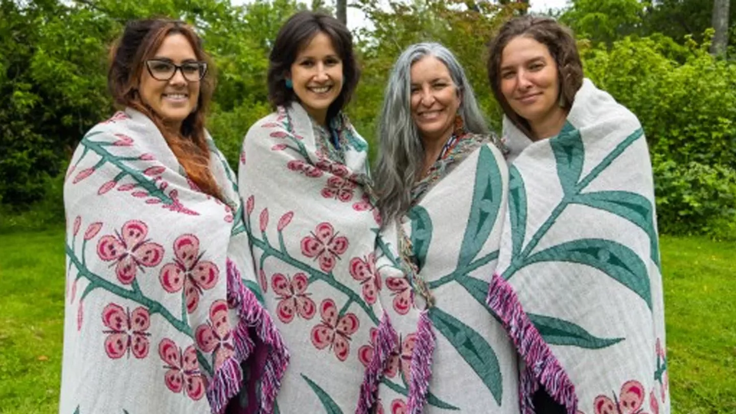 4 indigenous women wrapped in blankets