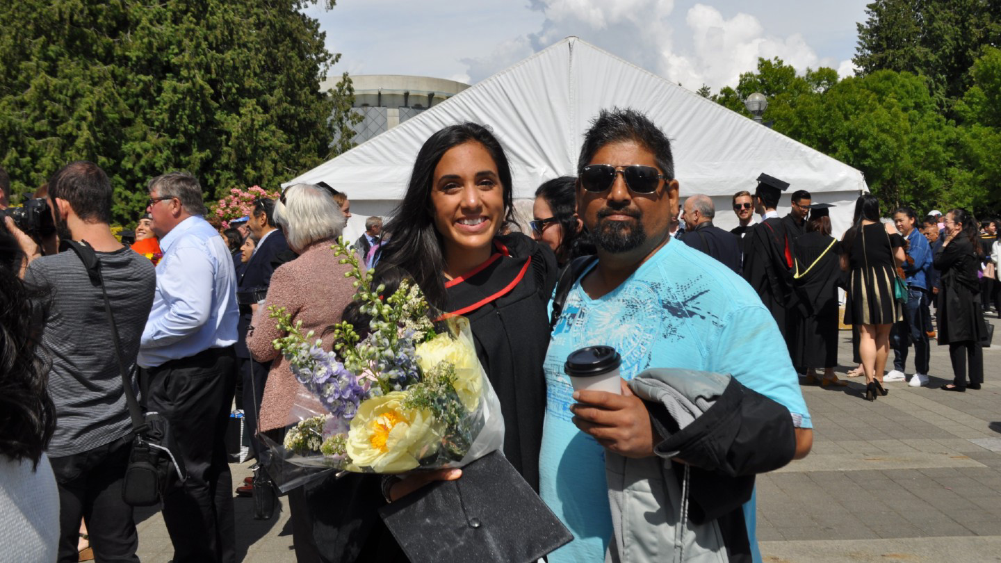 Kaitlyn Singh poses with her uncle at her nursing graduation