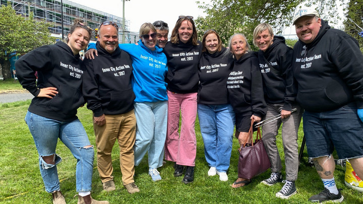 A group of people wear palliative care shirts.