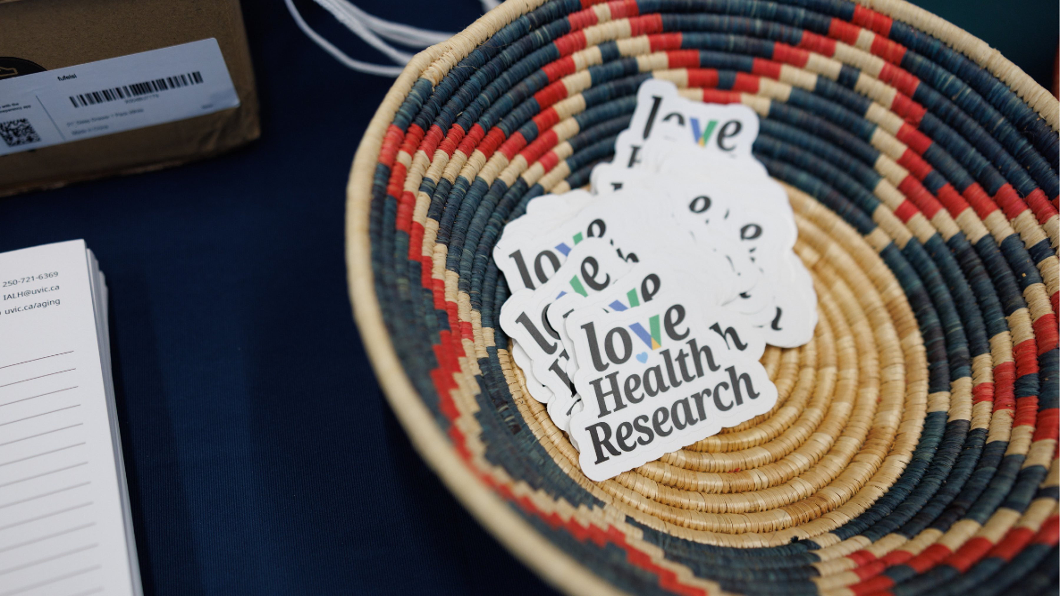 Basket of stickers saying "love health research".