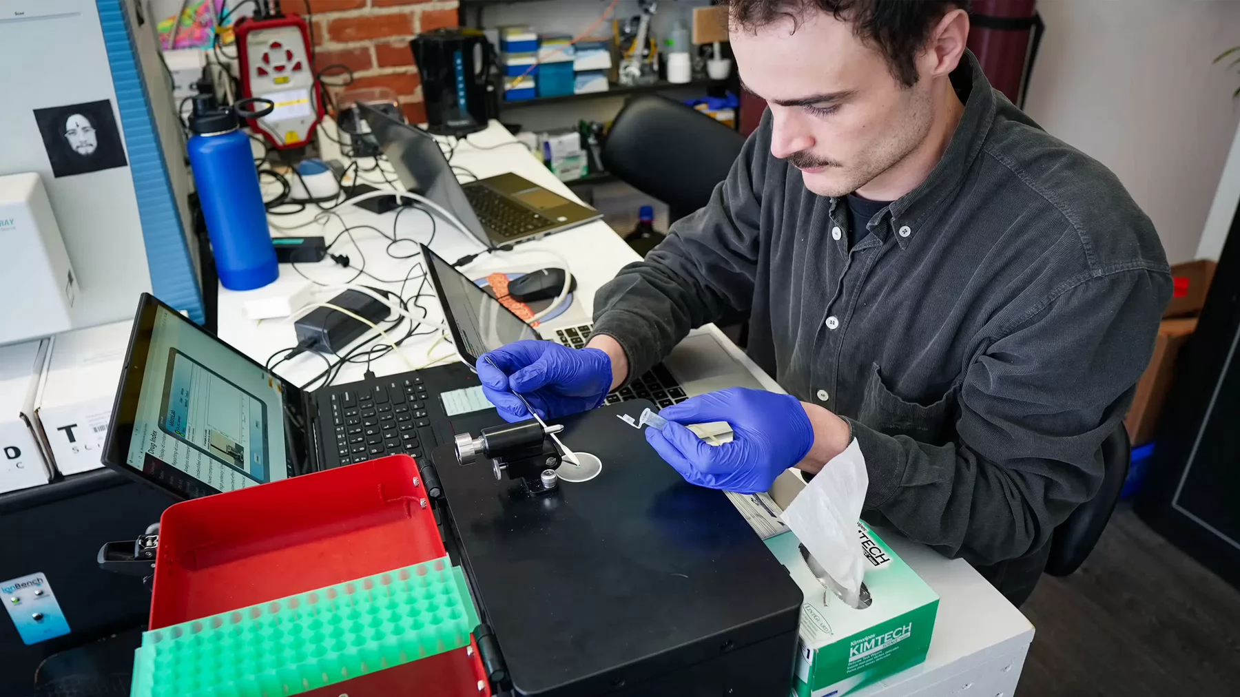 A person works on samples in a lab.