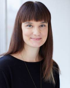 Woman with long dark hair smiling