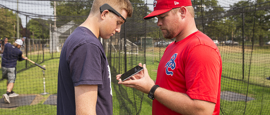 Anthony Pluta using an EEG device on a baseball player
