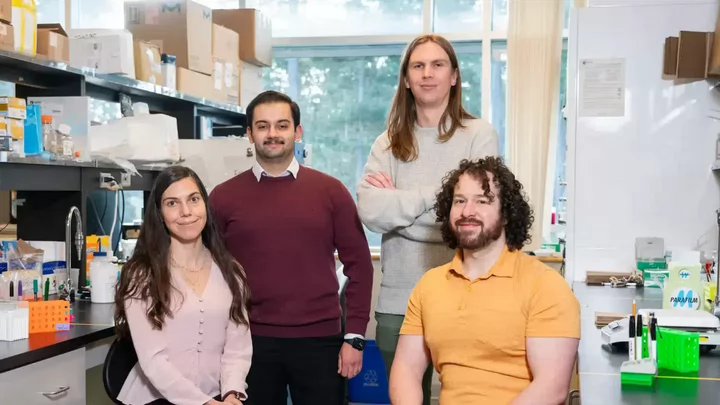 Four researchers—Marie-Ève Tremblay, Mohammadparsa Khakpour, Colby Sandberg, Fernando González Ibáñez—posing for a photo in their laboratory