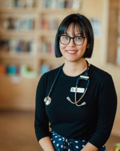 Portrait of Kim Cooper wearing black glasses and a stethoscope around her neck  