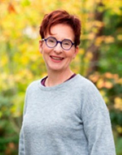 Dr. Kim Daly wearing a grey sweater