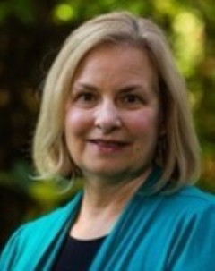 Dr. Kelli Stajduhar wearing a blue sweater