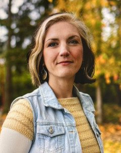 Kendra Allen wearing a yellow sweater and denim vest