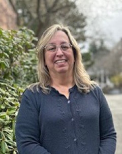 Angela Barry wearing a grey sweater