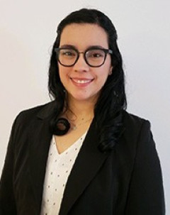 Melina Quijano wearing a black blazer and white blouse