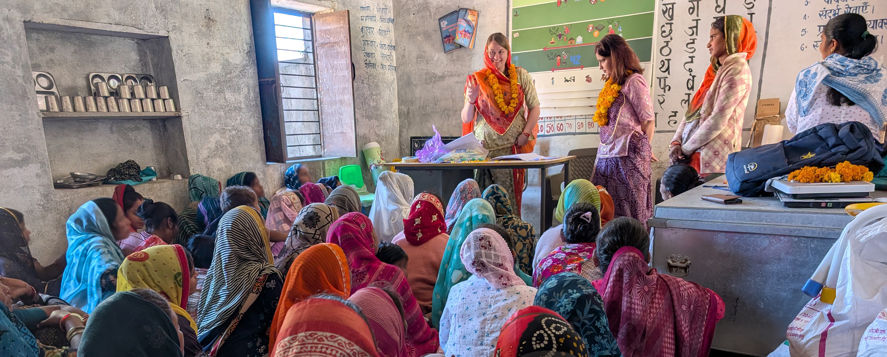 Patricha Ottsen and collaborators speak to a group of women in India