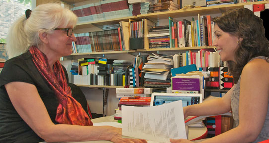 CYC professor with a student in an office