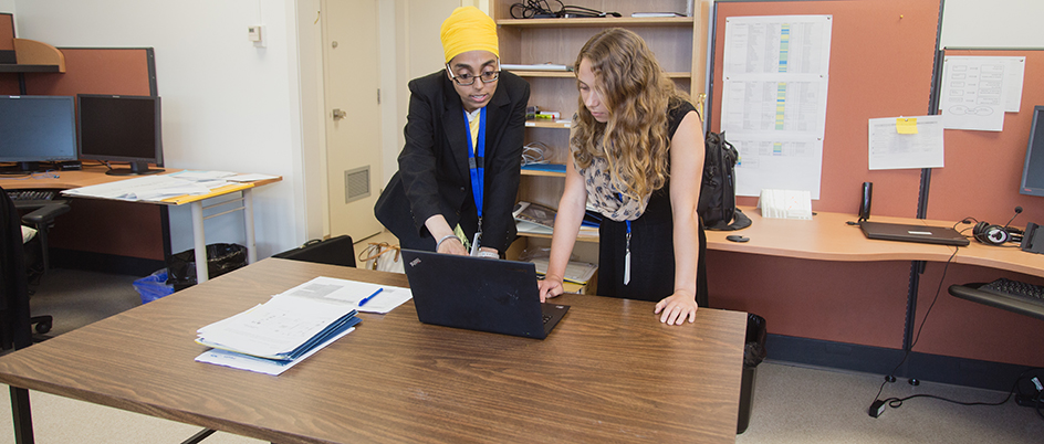 Two women looking at a computer