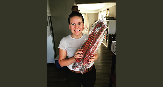 Robby Smoker-Peters holds wind dried salmon from her home community of the Lytton First Nation