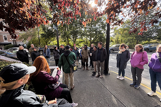 gathering of people in discussion outside in Autumn