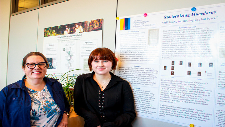 Janelle Jenstad (left) and Sofia Spiteri (right) stand in front of a research poster on the play Mucedorus.