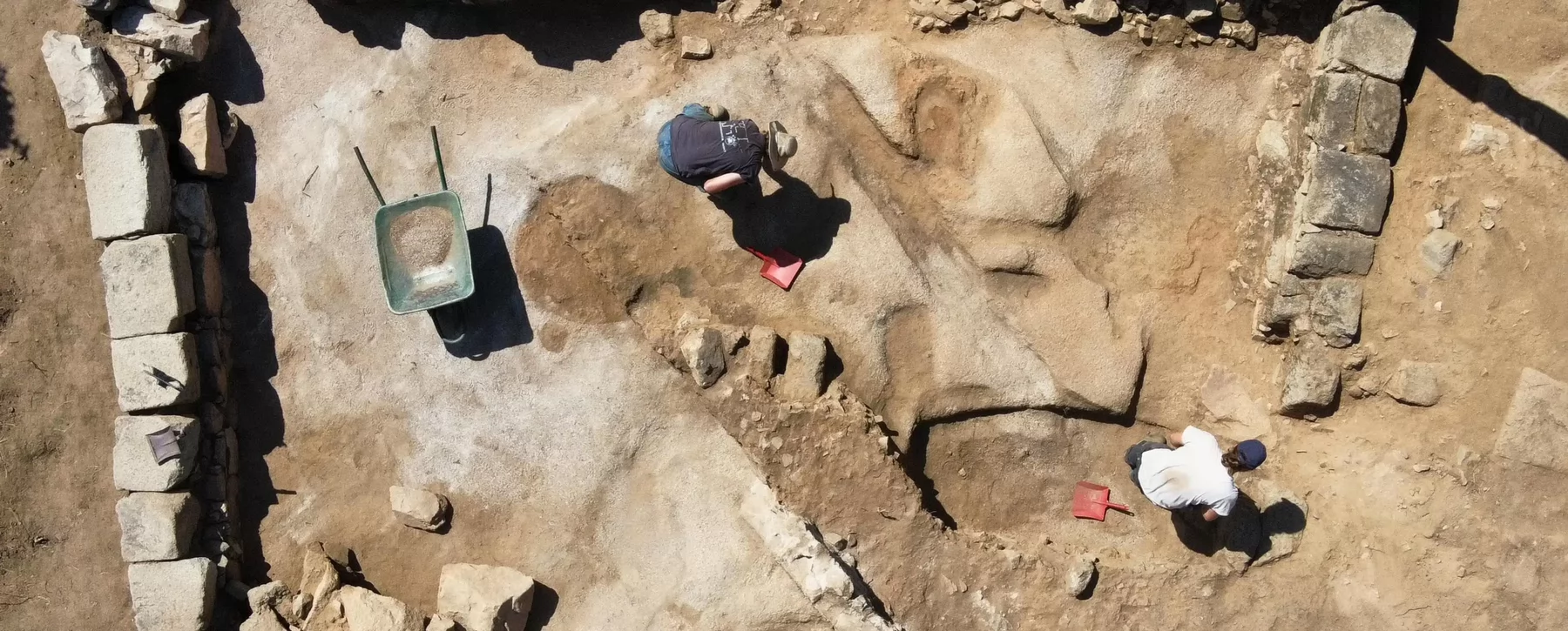 An aerial image of students working on an archaeological site.