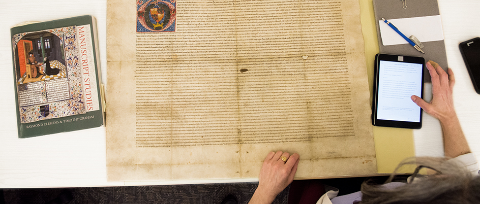 Researcher working with a Medieval manuscript