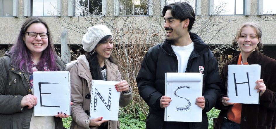 students holding  a letter for the new acronym "ENSH" 