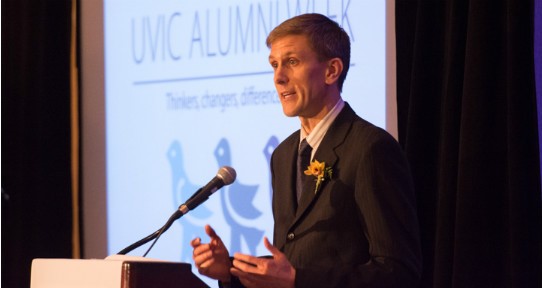 Lucas Ackroyd speaking at a podium during UVic Alumni Week
