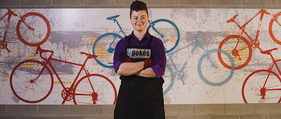 Courtenay Nielsen in front of a cycling mural