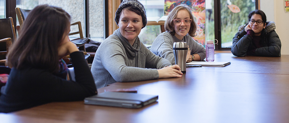 Students talking in a meeting room