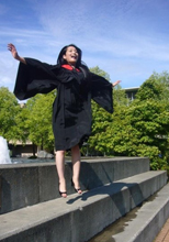 Convocating student jumps for joy